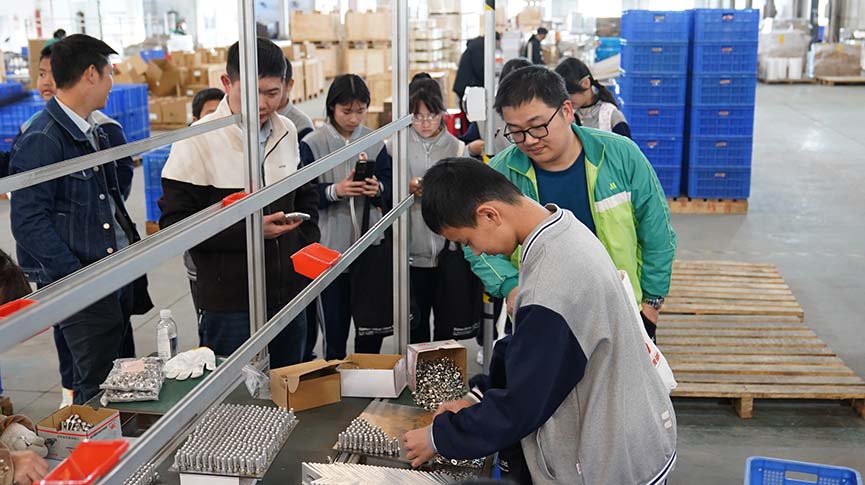 Student participates in hands-on assembly of components during the Mibet tour