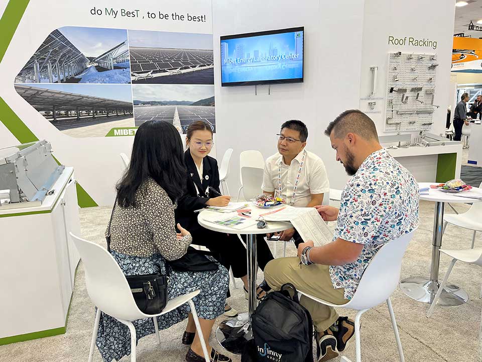 Visitors learn about products at the Mibet booth