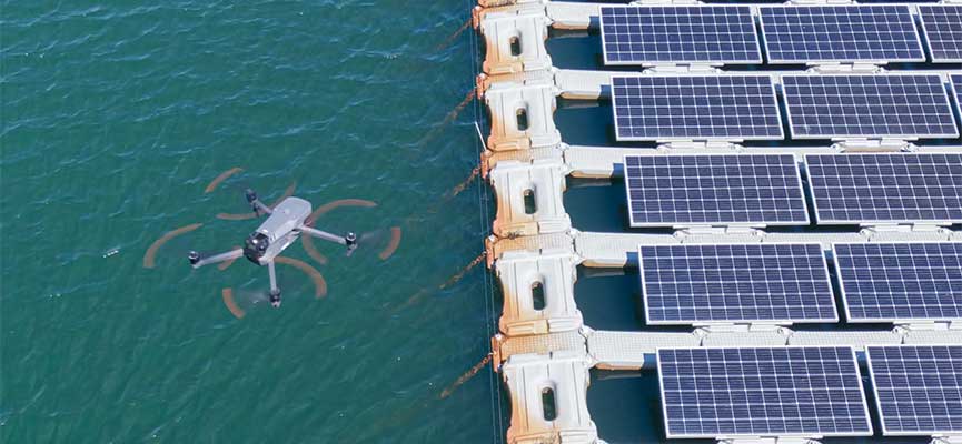 Drone inspecting floating solar panels from above.
