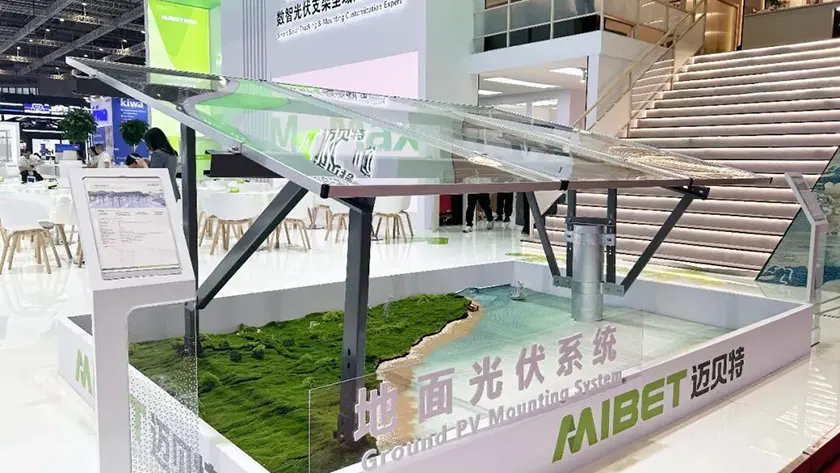 Mibet SNEC booth displaying a dual mock-up: a ground PV mount and a fishery-solar hybrid system.