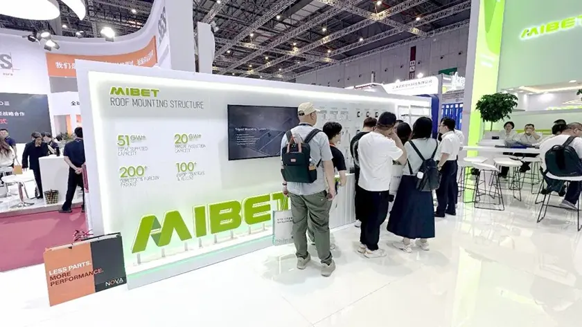 Mibet SNEC display of roof mounting components: hooks, standing seam clamps, trapezoidal mounts, mid and end clamps.