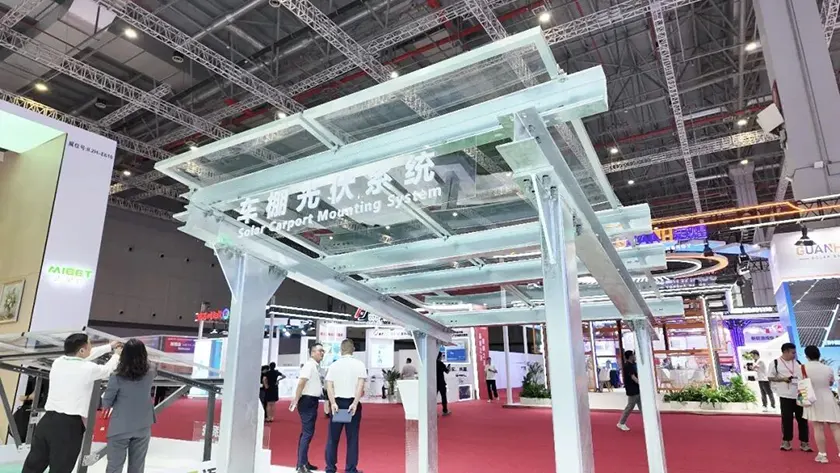Mibet SNEC booth displaying a dual-column solar carport mounting system.
