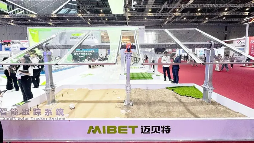 Mibet SNEC booth displaying a single-axis solar tracking system: torque tube and central drive.
