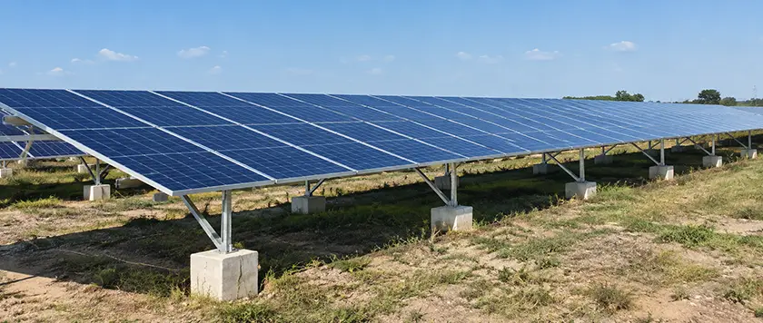 Fixed-tilt ground mount solar racking system anchored on concrete block foundations