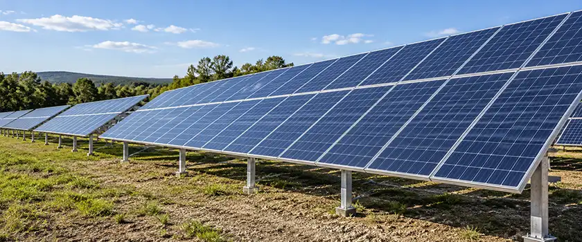 Fixed-tilt ground-mount solar racking system supporting PV panels in an open field.