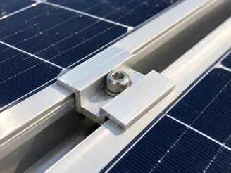 Aluminum solar panel mid clamp securing two adjacent module frames to a rail with one stainless steel bolt