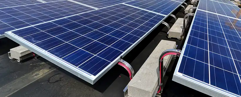 Solar ballast arrays on flat roofs